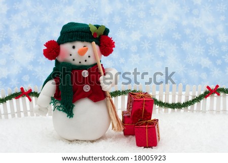 Snowman and white picket fence with green garland and red bow, merry Christmas