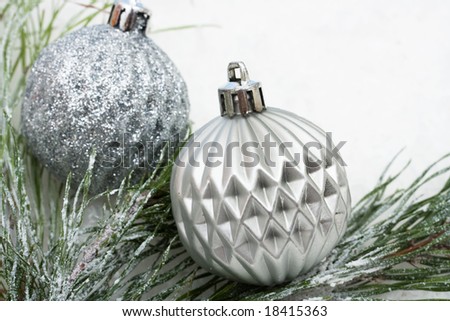 Christmas tree limb with silver glass ornaments on white background, Christmas border