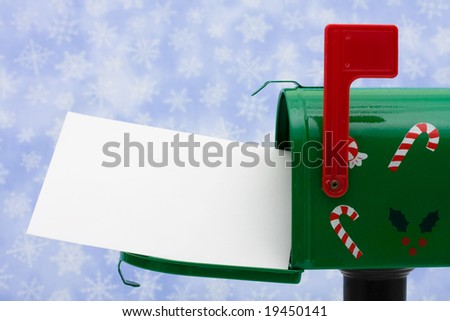 Green mailbox with blank card and the flag up with a snowflake background, mailbox