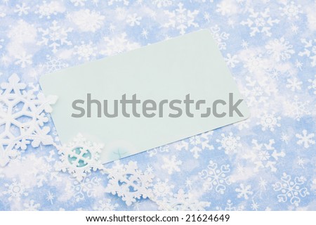 Blank card on blue snowflake background, happy holidays