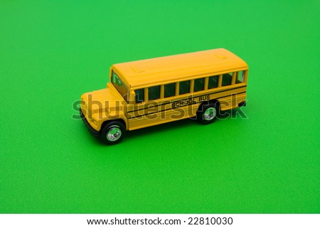 Yellow school bus sitting on green background, school bus
