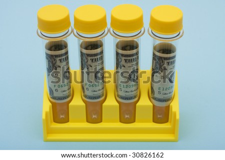 A set of yellow test tubes on a blue background, medical research costs