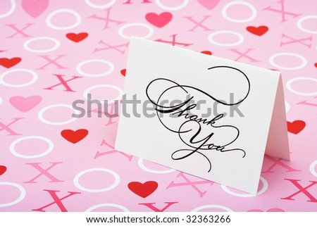 A white thank you card on a pink love background, love note