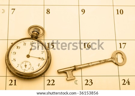 A pocket watch and a key on a calendar background, time management