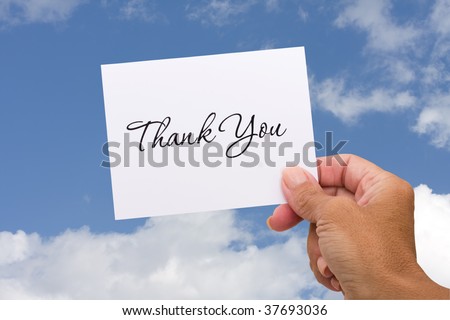 A thank you card sitting in hands on a sky background, blank card