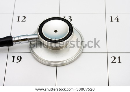 A stethoscope sitting on a calendar background, doctor?s appointment