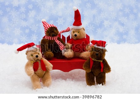 Teddy bears sitting on a red wooden bench on snow with a blue snowflake background, winter bears