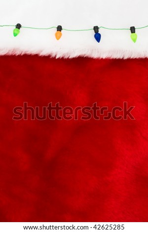 Colourful strung christmas lights on a red and white background, merry christmas