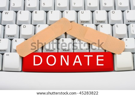 The word donate in red on a computer keyboard, Online donation