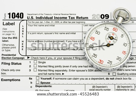 A stopwatch sitting on tax papers, File your taxes on time