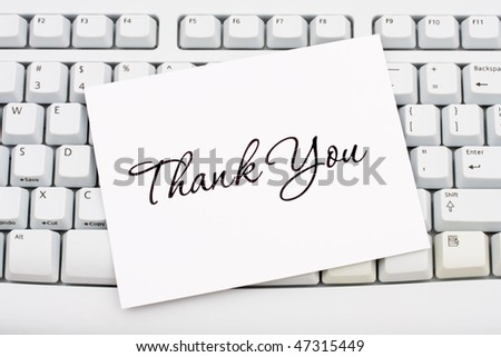 A thank you card sitting on a computer keyboard, online thank you