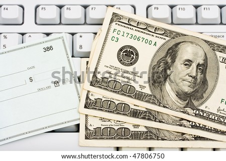 A blank check sitting on a computer keyboard, making money online