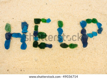 Beach glass spelling help in the sand, help