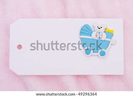 A blank gift tag with a baby stroller on a pink background, baby shower gift