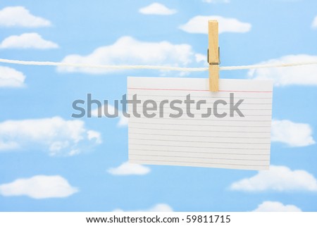 A blank index card hanging on a clothesline with copy space for your text