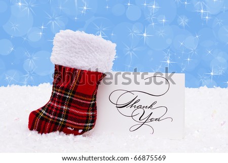 A stocking with a thank you card on a snow background, Christmas Time