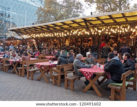 BUDAPEST, HUNGARY - NOVEMBER 20: Tourists enjoy the Christmas market in the city center on November 20, 2012 in Budapest, Hungary. This traditional Christmas fair attracts 600,000 visitors each year.