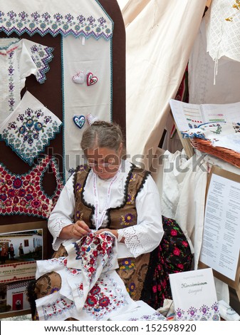 BUDAPEST - AUGUST 17: Unidentified woman makes traditional embroidery at the Festival of Folk Arts August 17, 2013 in Budapest, Hungary.