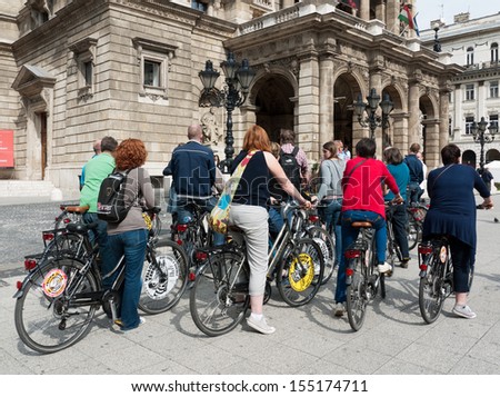 BUDAPEST - SEPTEMBER 22: Tourists on rented bikes in front of the Opera House on Andrassy Avenue September 22, 2012 in Budapest, Hungary.