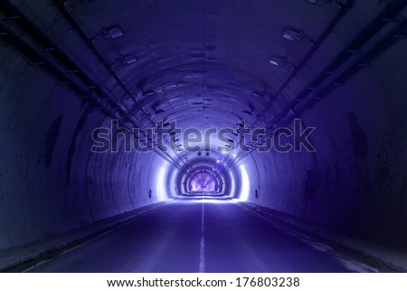 road tunnel tinted blue with lights and road line