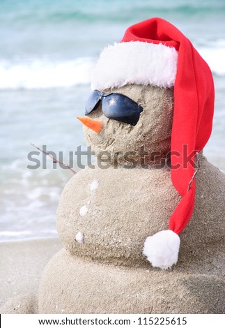 Snowman made out of sand. Holiday concept can be used for New Year and Christmas Cards