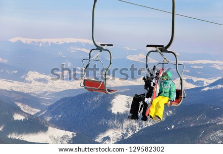 Snowboarders couple on a ski lift