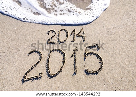 Happy New Year 2015 replace 2014 concept on the sea beach