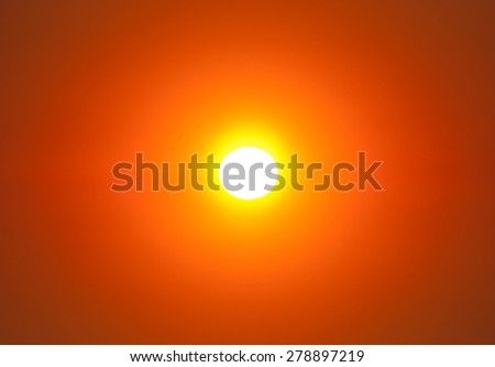 Bright large sun close-up on sunset sky with fairy yellow orange gradient colors