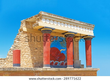 Ancient ruins of Knossos palace, restored North Entrance with charging bull fresco against blue sky. Heraklion, Crete, Greece.