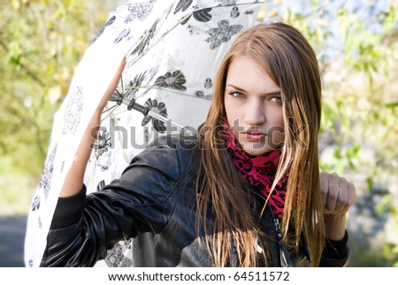 passionate look of attractive girl in black leather jacket with white umbrella in autumn day