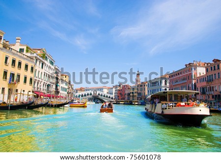 Venice Grand canal with gondolas and Rialto Bridge, Italy in summer bright day