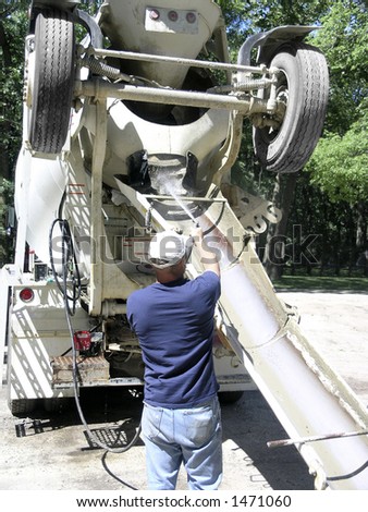 Man Washes out ready-mix concrete truck