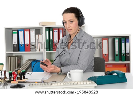 businesswoman listening music in office