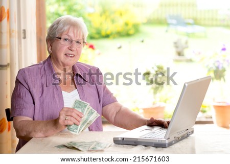 friendly older woman with money and computerfriendly