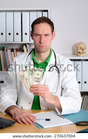 young doctor in his office with dollars is angry