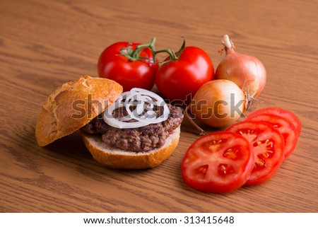 home made hamburger with meat, onion and tomato