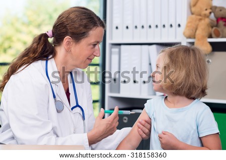 female pediatrician in white lab coat injected a medicament