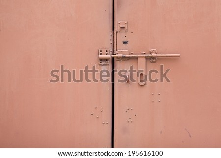old style padlock on steel garage gate, vintage object and background