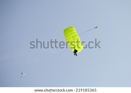 Two parachute jumper against blue sky background