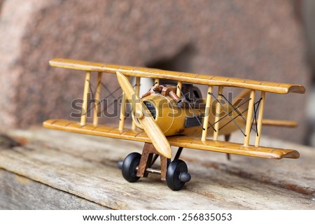 close-up of  a wooden toy plane hand carved model on old wood box background