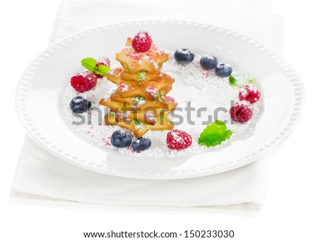 Christmas dessert - tree of cookies with berries  isolated on white background