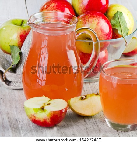 Apple juice and apples on wooden table. Selective focus