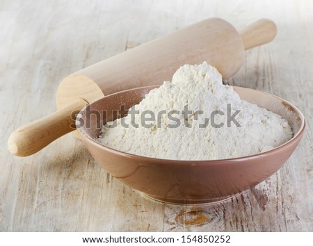 Flour on a wooden table. Selective focus