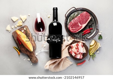 Red wine Primitivo with appetizers on gray background. Traditional alcohol drinks. Top view, flat lay, copy space Foto d'archivio © 