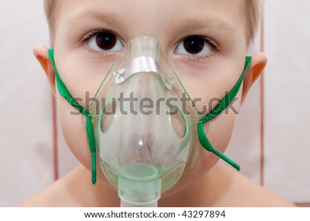 Portrait of a boy in a mask for inhalation closeup