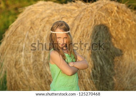 portrait of a child girl wearing sunglasses with developing hair in the wind