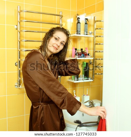 Woman in the bathroom washing her hair