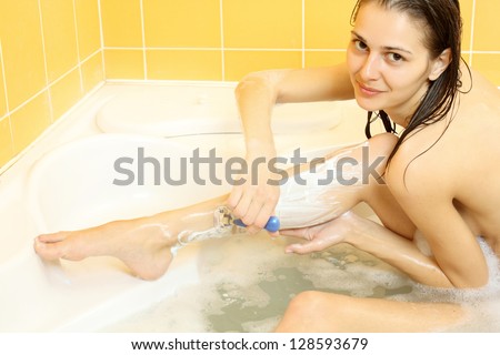 Nice simple naked girl shaves legs in bath