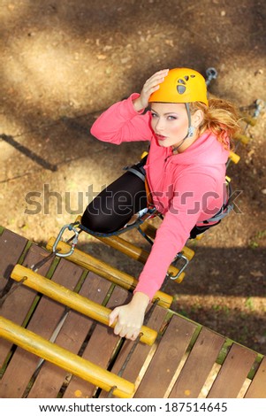 Beautiful girl climber climbs up the stairs