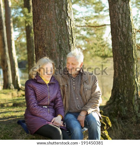 Beautiful elderly couple embracing and enjoying life in the forest at sunset. couple of grandparents embracing